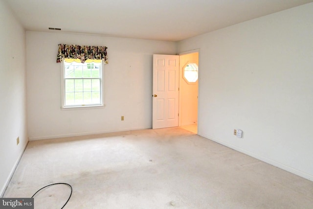 unfurnished room with light colored carpet