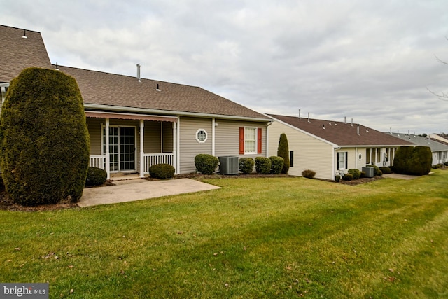 rear view of house featuring a yard, a patio, and central AC unit