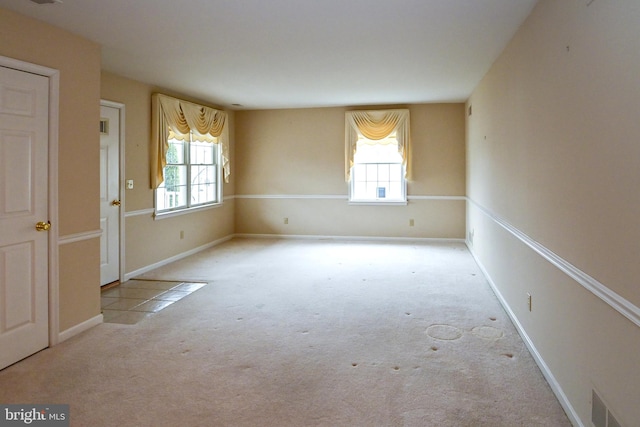 spare room with light colored carpet