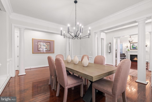 dining room with dark hardwood / wood-style flooring, ornamental molding, and a chandelier