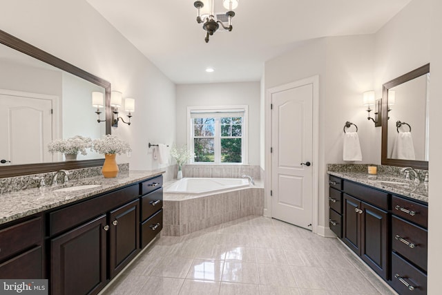 bathroom with vanity and a relaxing tiled tub