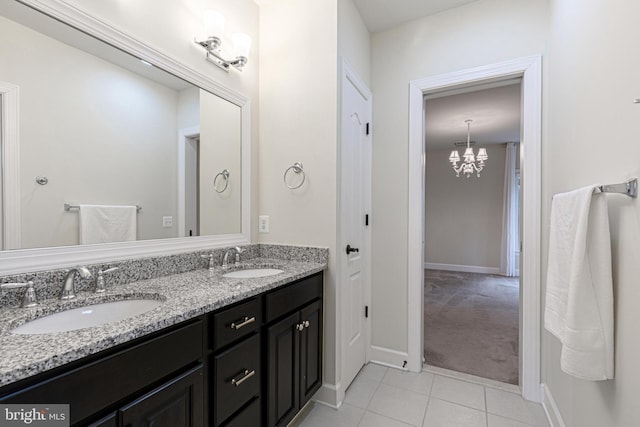 bathroom featuring tile patterned floors, vanity, and a notable chandelier