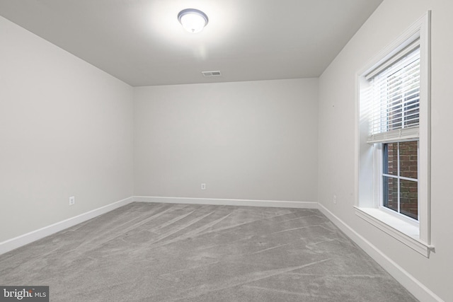 unfurnished room featuring light colored carpet