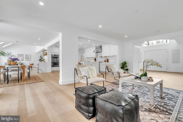 living room featuring light hardwood / wood-style floors and sink