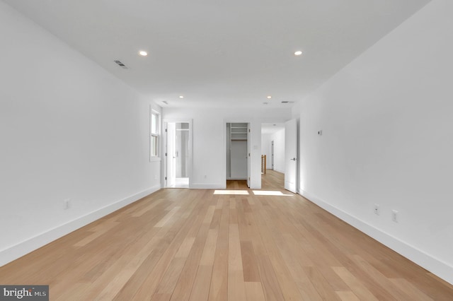 empty room with light hardwood / wood-style flooring