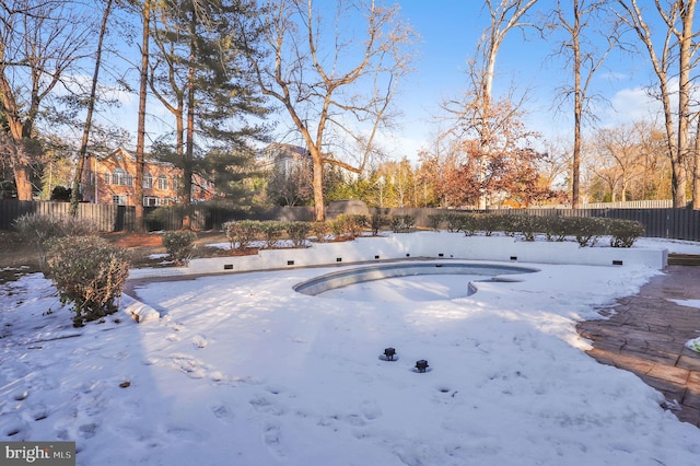 yard covered in snow featuring an empty pool