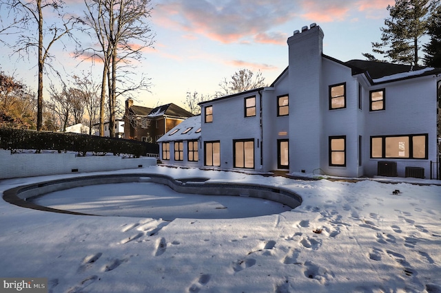 view of snow covered rear of property