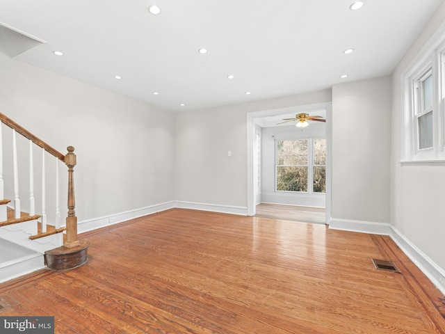 unfurnished living room featuring light hardwood / wood-style flooring and ceiling fan