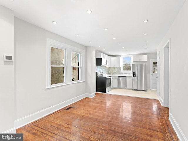 unfurnished living room featuring light wood-type flooring