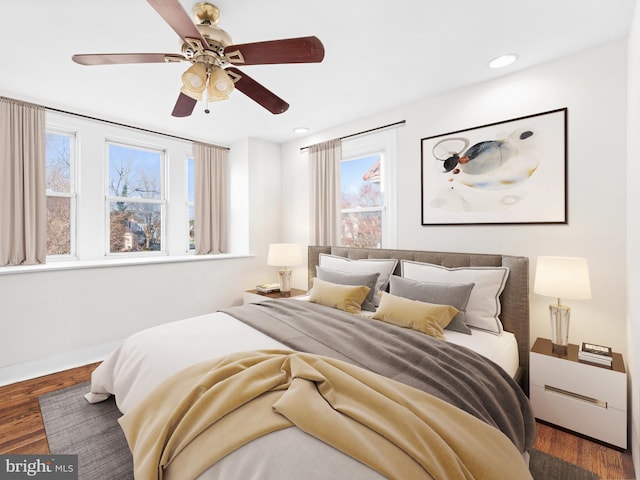 bedroom with ceiling fan and dark hardwood / wood-style floors