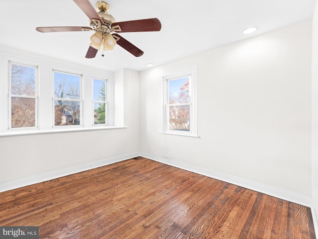 unfurnished room featuring hardwood / wood-style flooring, ceiling fan, and a wealth of natural light