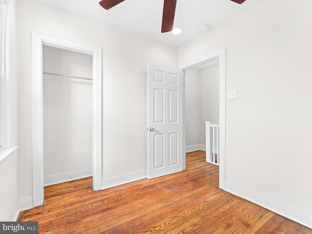 unfurnished bedroom with ceiling fan, a closet, and light hardwood / wood-style flooring