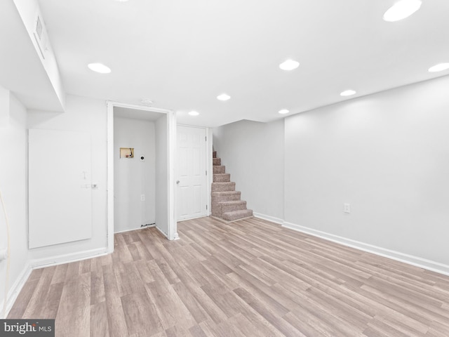 basement with light hardwood / wood-style flooring