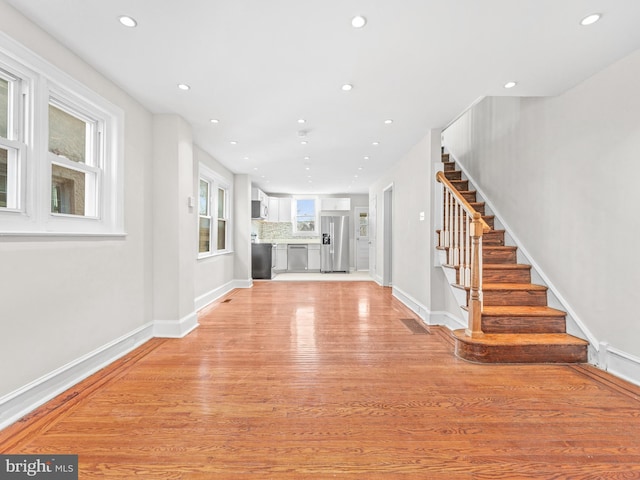 unfurnished living room featuring light wood-type flooring