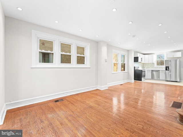 unfurnished living room featuring light wood-type flooring