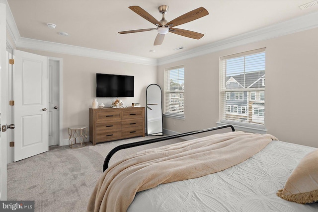 bedroom featuring ceiling fan, crown molding, and light carpet