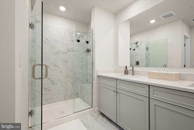 bathroom featuring vanity and an enclosed shower