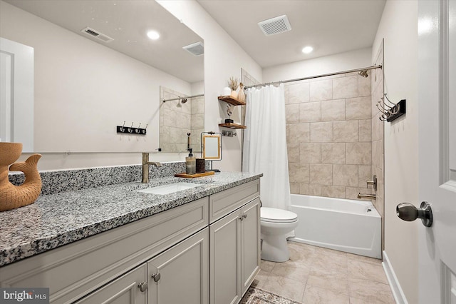 full bathroom featuring tile patterned floors, vanity, toilet, and shower / bath combo