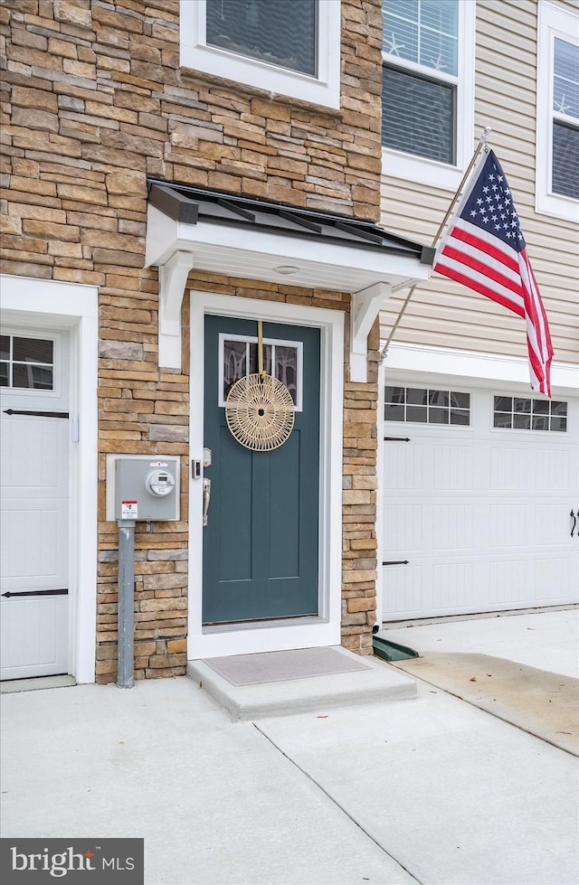 view of exterior entry with a garage