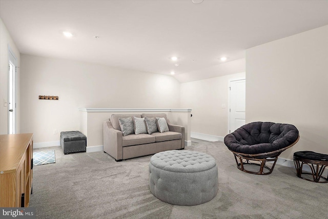 carpeted living room featuring lofted ceiling