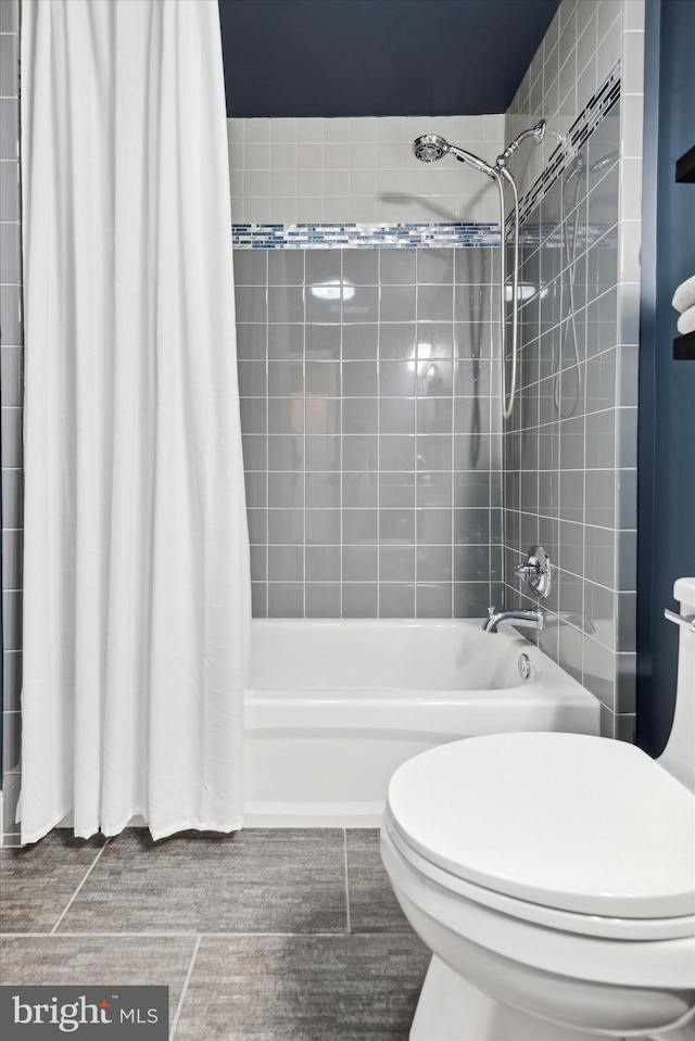 bathroom featuring shower / bath combo and toilet