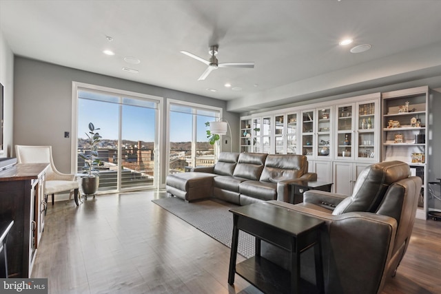 living room with hardwood / wood-style floors and ceiling fan