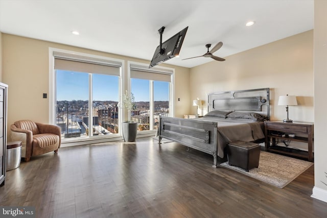 bedroom featuring dark hardwood / wood-style floors, ceiling fan, and access to outside