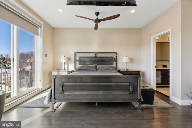 bedroom featuring ensuite bathroom, ceiling fan, and dark hardwood / wood-style floors