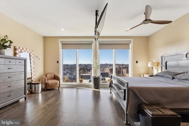 bedroom with dark hardwood / wood-style floors and ceiling fan