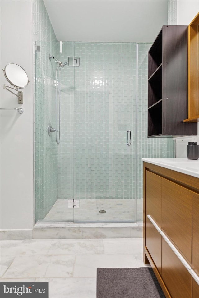 bathroom with vanity and a shower with door