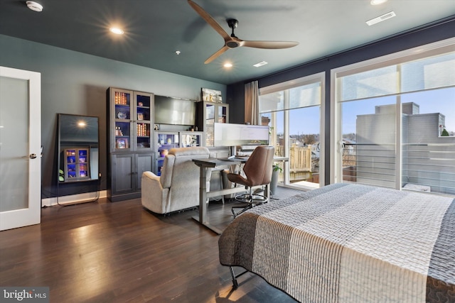 bedroom with dark hardwood / wood-style floors and ceiling fan