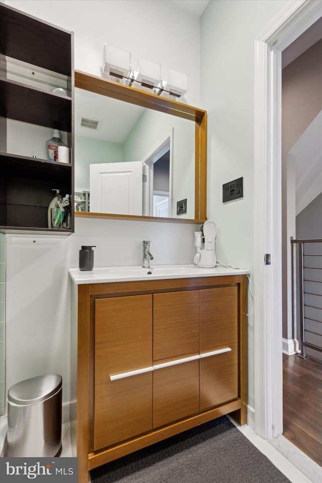 bathroom with vanity and hardwood / wood-style flooring