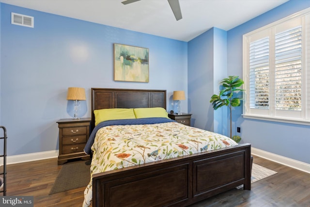 bedroom with ceiling fan and dark wood-type flooring