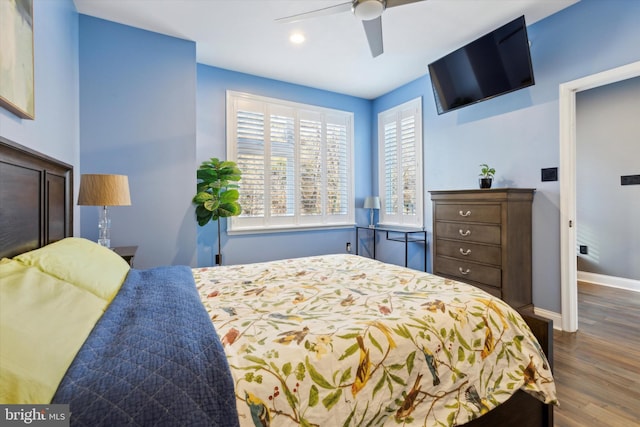 bedroom with ceiling fan and dark wood-type flooring