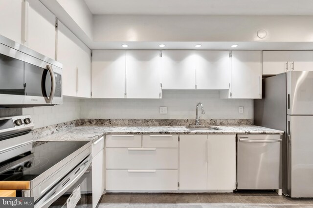 kitchen with sink, white cabinets, and stainless steel appliances