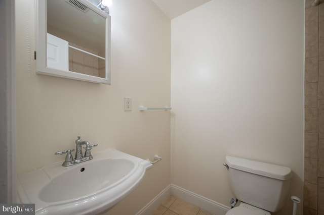 bathroom featuring tile patterned floors, toilet, and sink