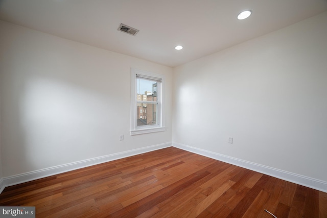 unfurnished room with hardwood / wood-style flooring