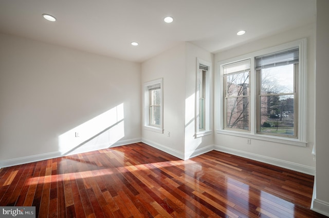 spare room featuring dark wood-type flooring