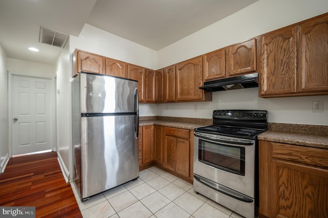 kitchen featuring light tile patterned floors and appliances with stainless steel finishes