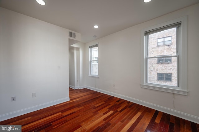 empty room featuring dark wood-type flooring