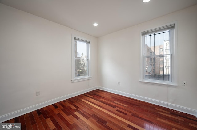 spare room with wood-type flooring