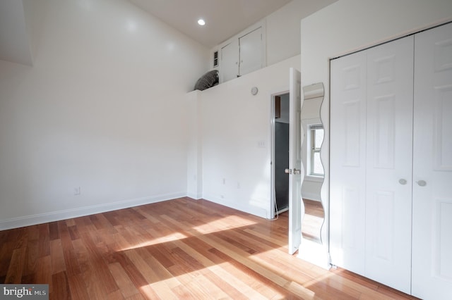 unfurnished bedroom with a closet and light hardwood / wood-style flooring