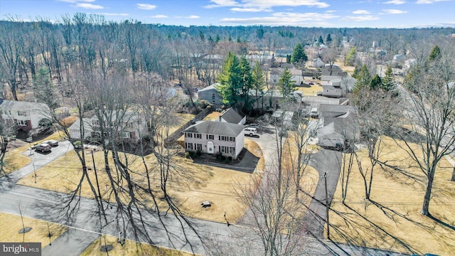 drone / aerial view featuring a wooded view