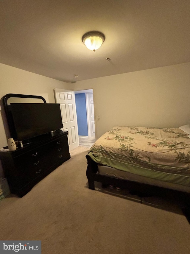 bedroom featuring light carpet