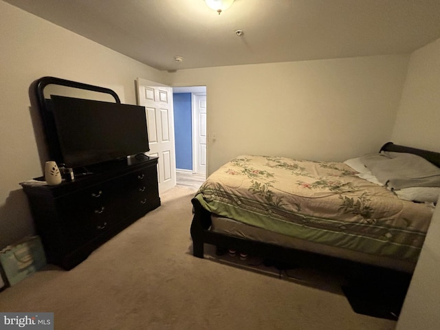 bedroom featuring light carpet