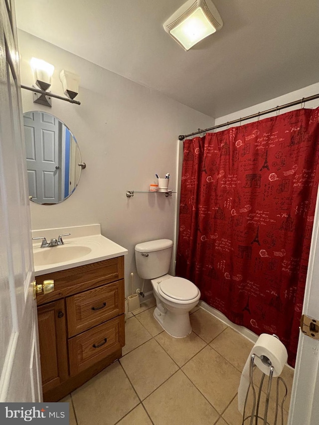 bathroom featuring tile patterned floors, vanity, curtained shower, and toilet