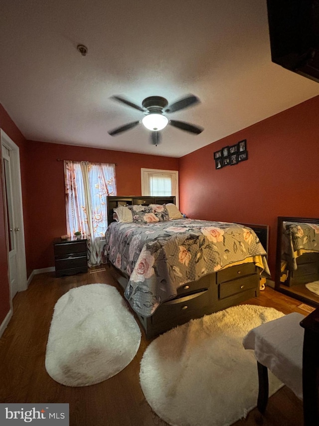 bedroom with ceiling fan and wood-type flooring