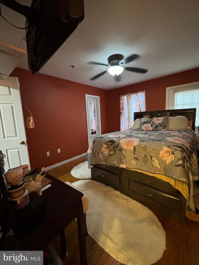 bedroom with hardwood / wood-style floors and ceiling fan