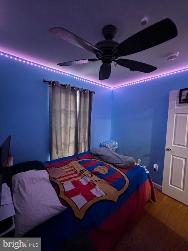 bedroom with wood-type flooring and ceiling fan