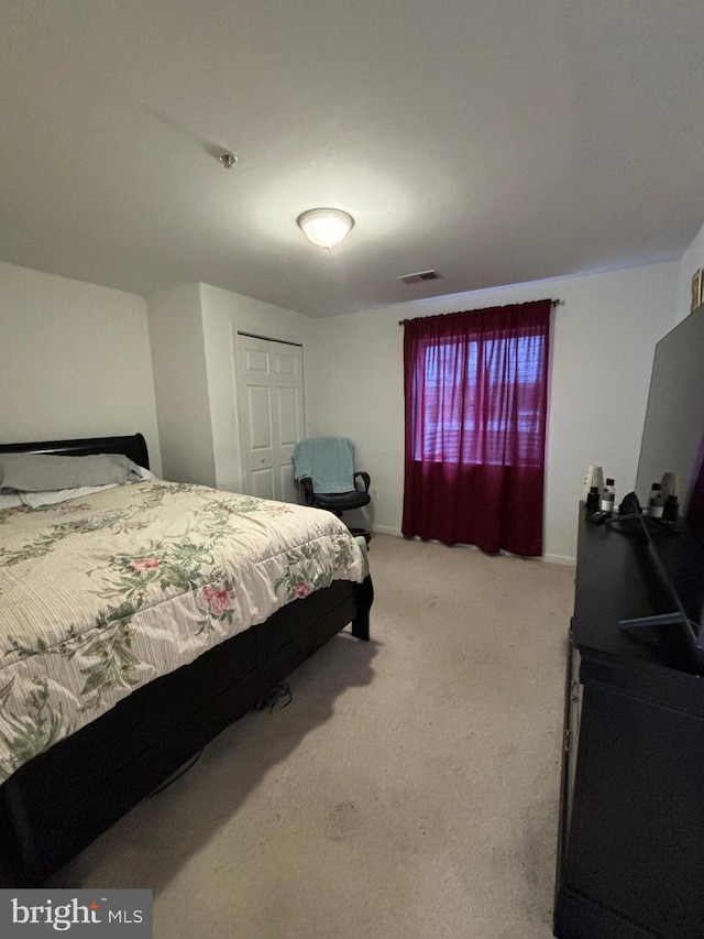 carpeted bedroom featuring a closet